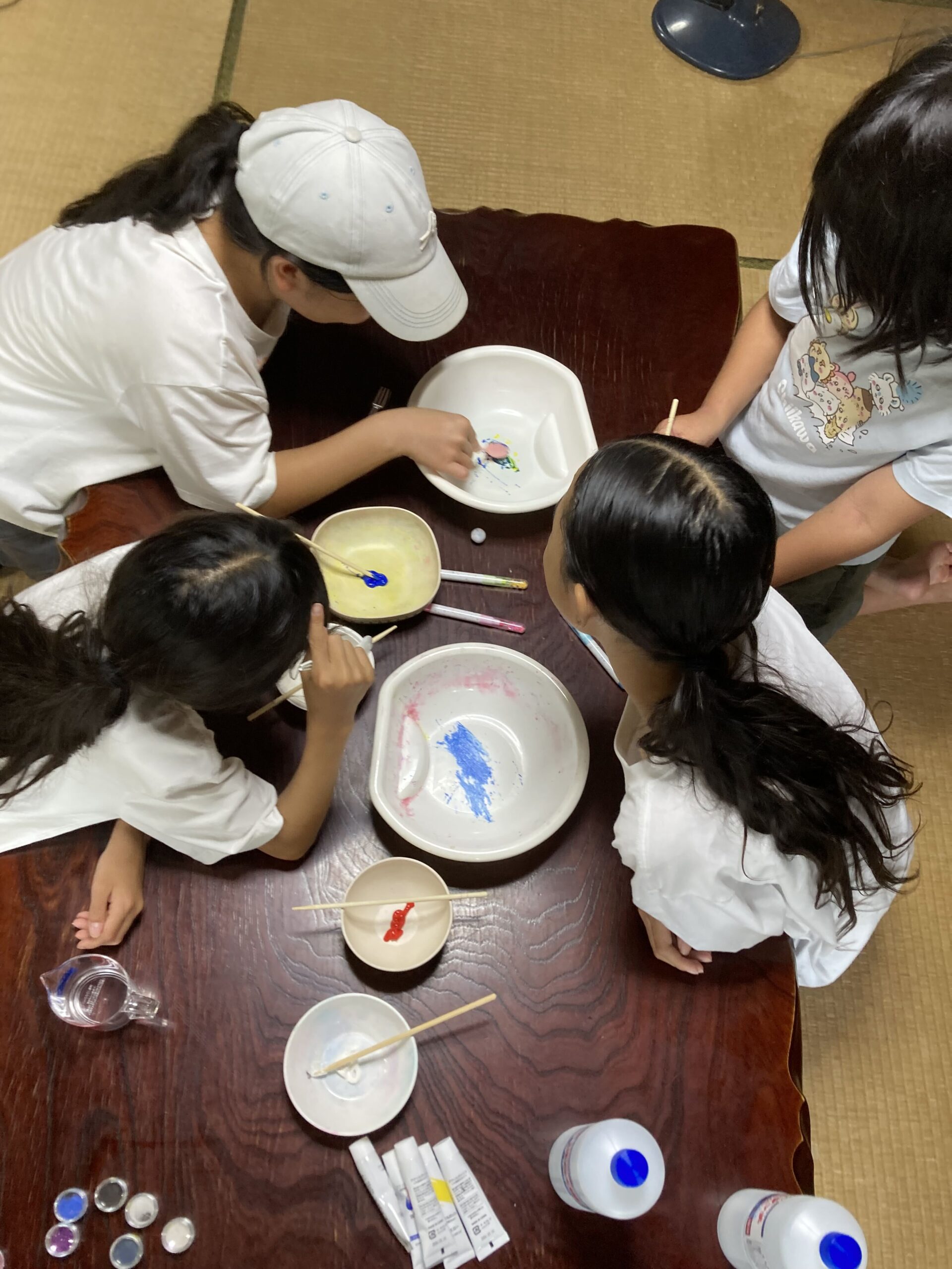 色を付けながらスライムを混ぜる子どもたちを上から見た様子