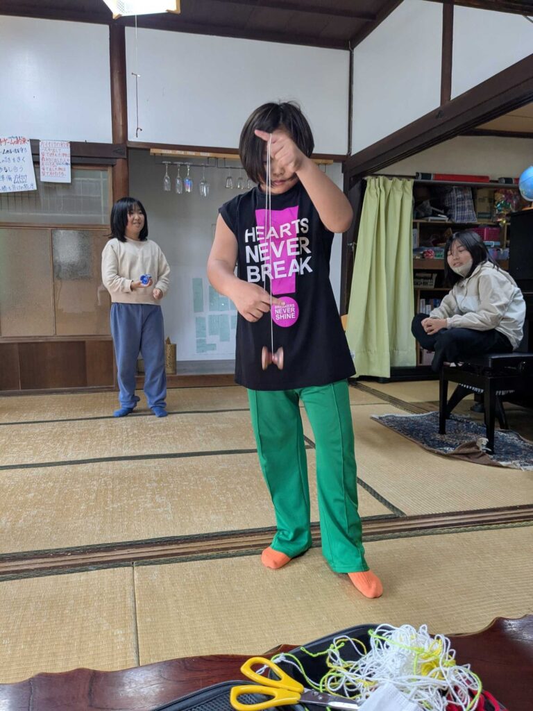 畳の部屋でヨーヨーをする子どもたち